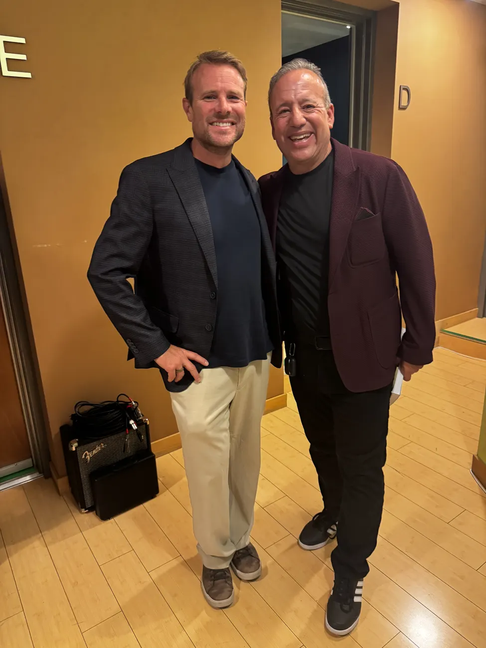 Brent Nickles standing with Dave Meltzer, both in blazers