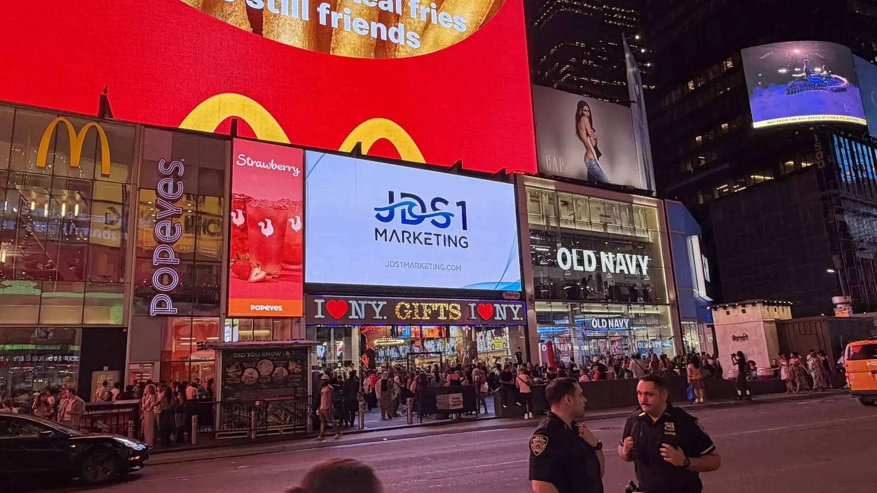 The JDS1 Marketing logo on a digital billboard in Times Square at night
